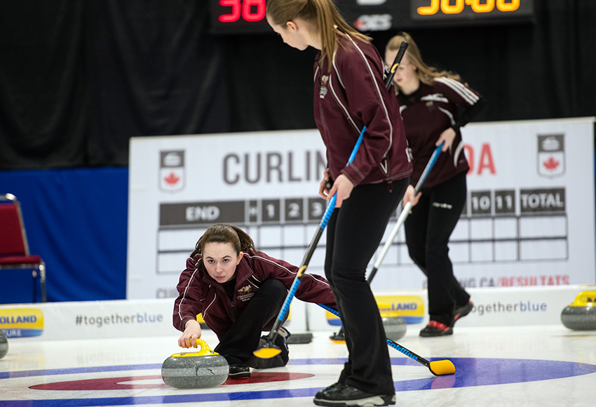 Griffins skip Ashton Simard lets a shot fly against Douglas College in Friday's opening draw of the CCAA national championship, while second Andie Kurjata prepares to sweep (CCAA photo).