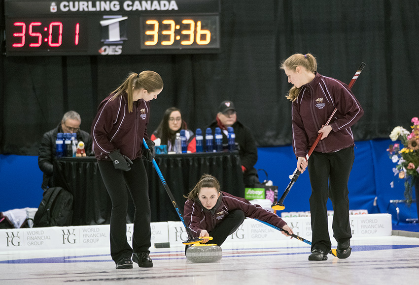Ashton Simard lets a shot go with sweepers Andie Kurjata, left, and Taitan Hagglund at the ready during CCAA nationals action. They beat UAlberta-Augustana 8-7 to advance to the national final on Tuesday morning (CCAA photo).