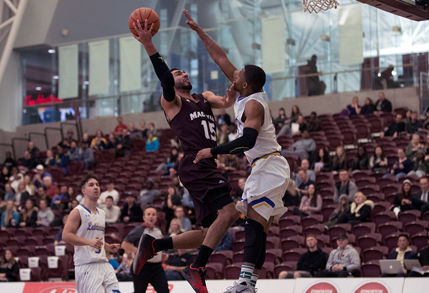 Ali Raza drives the hoop with a Lethbridge defender in his face on Saturday. MacEwan shot just 28.8 per cent from the field in the contest (Eduardo Perez photo).