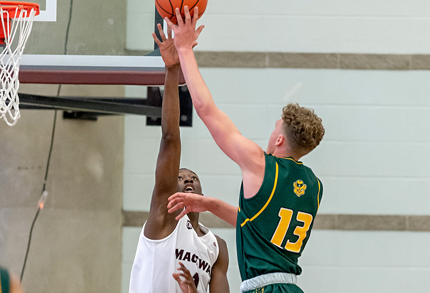 Abdullah Shittu gets a hand on a shot attempt from Alberta's Adam Paige during a meeting earlier this season. The MacEwan Griffins forward leads Canada West with 16 blocks in six games (Chris Piggott photo).