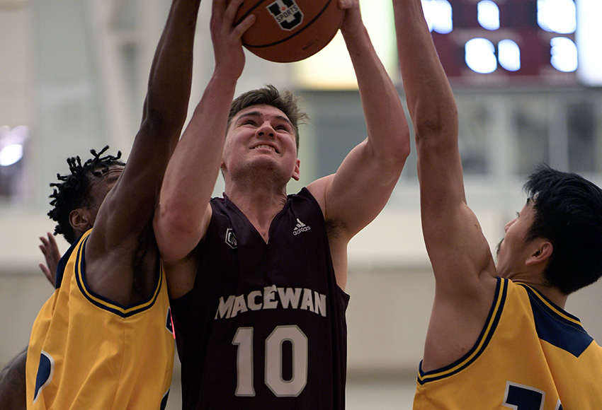 Harrison Lane cuts through a pair of defenders to the hoop during the final home game of his six-year MacEwan Griffins career on Saturday (Chris Piggott photo).