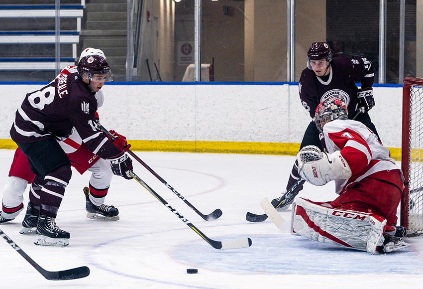 Nicolas Correale, left, and teammate Ryan Baskerville hunt for a loose puck against SAIT's Payton Lee during a game earlier this season. The Griffins scored on the play (Matthew Jacula photo).