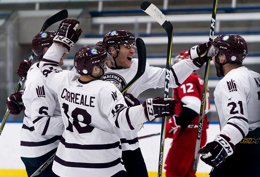 Brett Njaa, left, celebrates with Austin Shmoorkoff and other teammates after setting him up for a goal against SAIT on Feb. 20. Njaa's assist on the play would break MacEwan's program record for most in a career (Matthew Jacula photo).