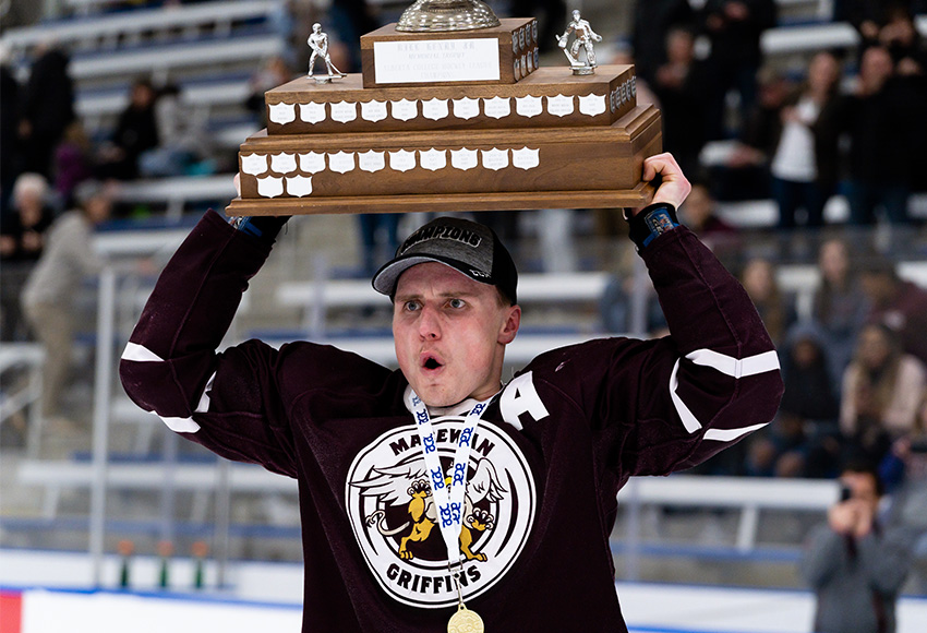 Ryan Baskerville hoists the ACAC Championship trophy on Saturday night. After scoring the golden goal that sealed MacEwan's third-straight win and leading MacEwan in playoff scoring with seven points, he was named ACAC playoff MVP (Matthew Jacula photo).