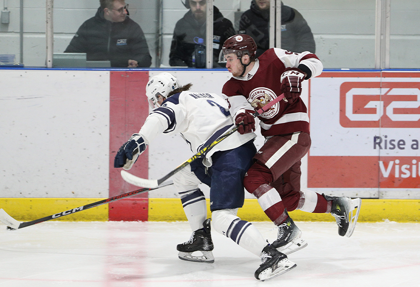 Ethan Strang tries to leap around Cougars defenceman Kyle Walker on Friday. He scored MacEwan's lone goal in a 4-1 loss to MRU in Game 1 of their Canada West quarter-final series (Adrian Shellard photo).