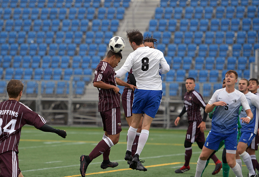 Kapri (Marcus) Simmons gets a header on a ball in front of a crowd of players from Sunday combatants MacEwan and Victoria. The visiting Vikes won 3-1 (Chris Piggott photo).