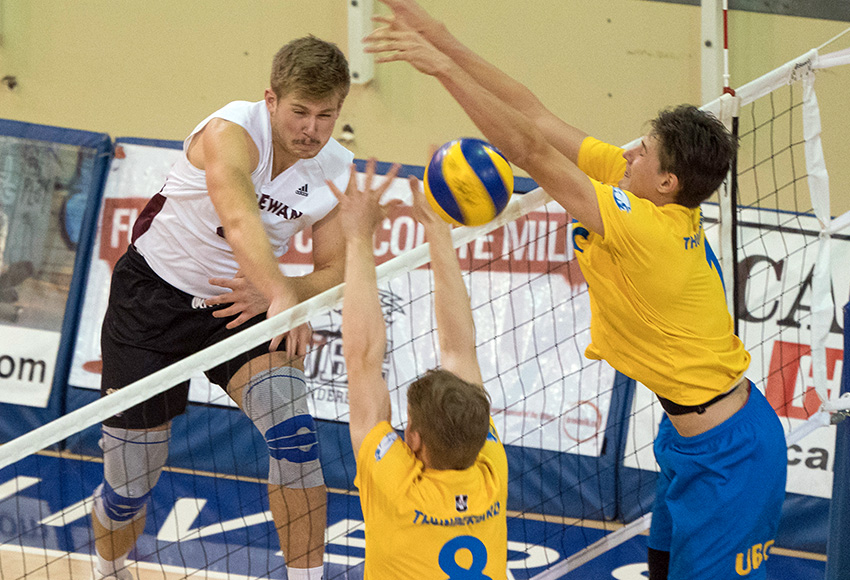 Shane Kerrison hits one off the UBC block on Friday. He led the Griffins with eight kills in a losing effort (Rich Lam / UBC Thunderbirds).