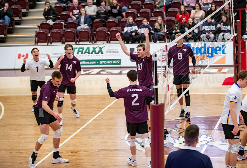 The Griffins celebrate after Seth Birkholz's kill gave them a 15-10 win in Set 5 and their first win of the season (Eduardo Perez photo).