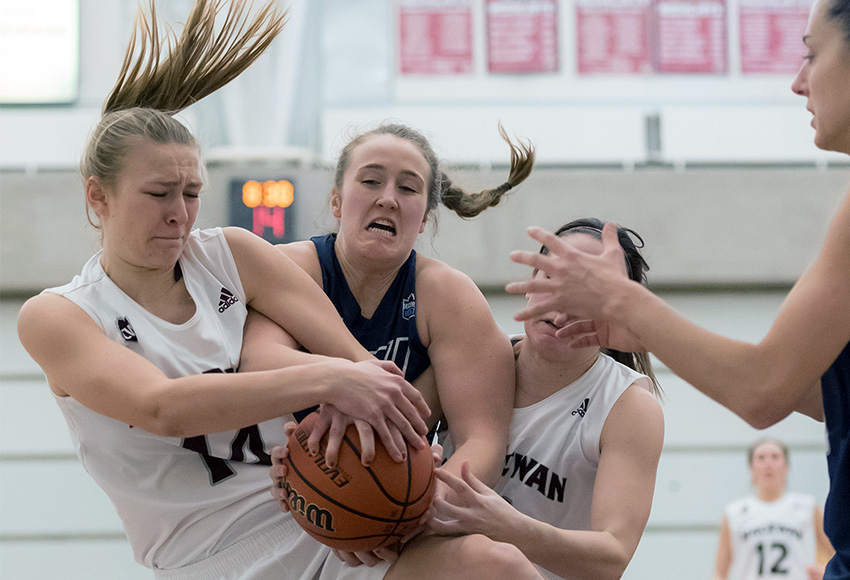 MacEwan's Shannon Majeau, left, and Paige Knull battle MRU's Charity Marlett for the ball last weekend. The Griffins are aiming to get back to a more intense defensive effort this weekend at UBC (Chris Piggott photo).