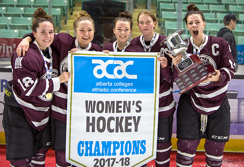 Griffins leadership group Morgan Casson, left, Shanya Shwetz, Nikki Reimer, Raven Beazer and Sydney Thomlison celebrate with the 2018 trophy and banner on March 9 in Red Deer (Tony Hansen, RDC Athletics).