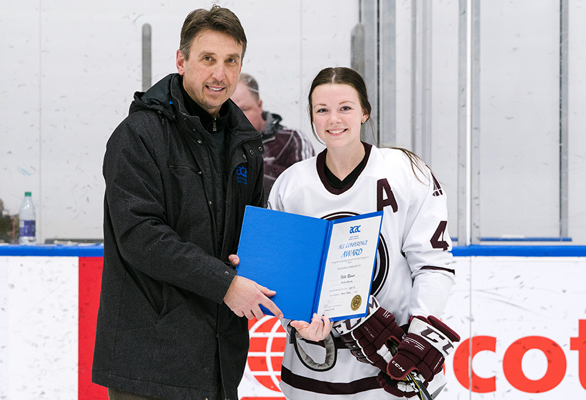 Nikki Reimer, right, seen receiving her All Conference Second Team award from the ACAC's Mark Kosak last season, has been named the new captain of the Griffins women's hockey team (Matthew Jacula photo).
