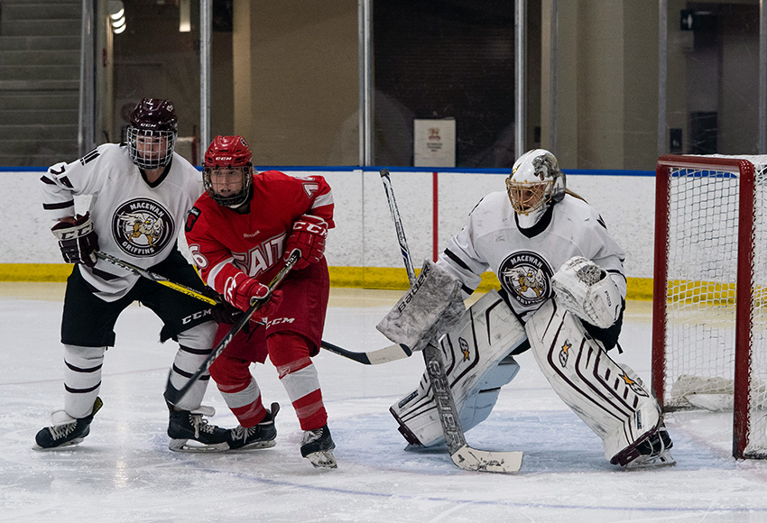 MacEwan Griffins defenceman Jenna Thompson keeps SAIT's Brittany MacDonald in check in front of goalie Sandy Heim during an ACAC game last month (Matthew Jacula photo).