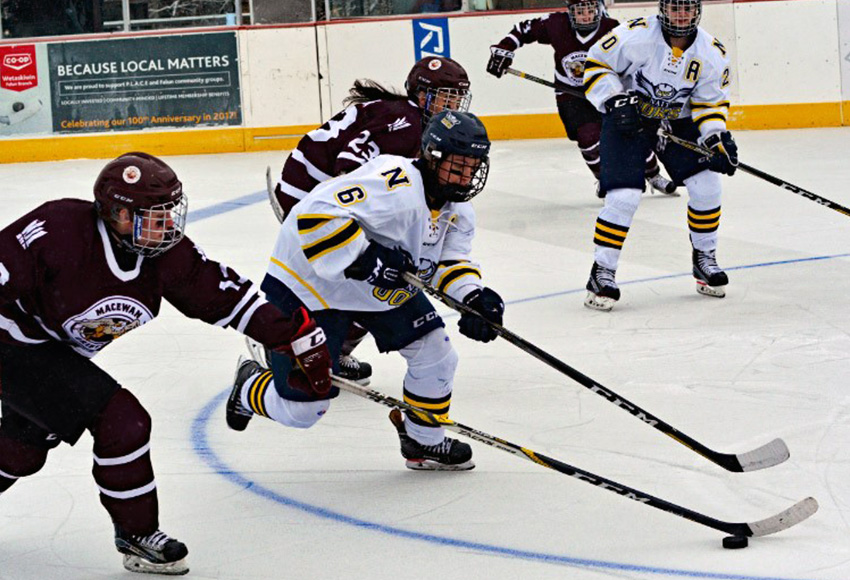 Raven Beazer reaches for the puck ahead of NAIT's Cass Lyttle during a Dec. 1 outdoor game in Falun, Alta. - the last time the two ACAC rivals met this season (Byron Weaver photo).
