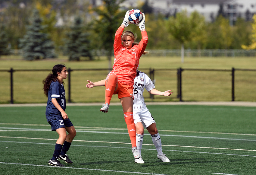 Emily Burns makes a save in front of MRU striker Natalie DeMarco on Saturday. Earlier in the contest, she stopped DeMarco on a penalty shot (Chris Piggott photo).