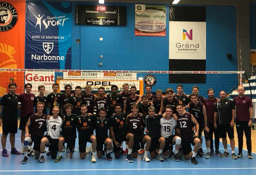 The MacEwan Griffins men's volleyball team poses in the gym of Montpellier, France pro club team Narbonne, a squad they defeated 3-1 on Aug. 27.
