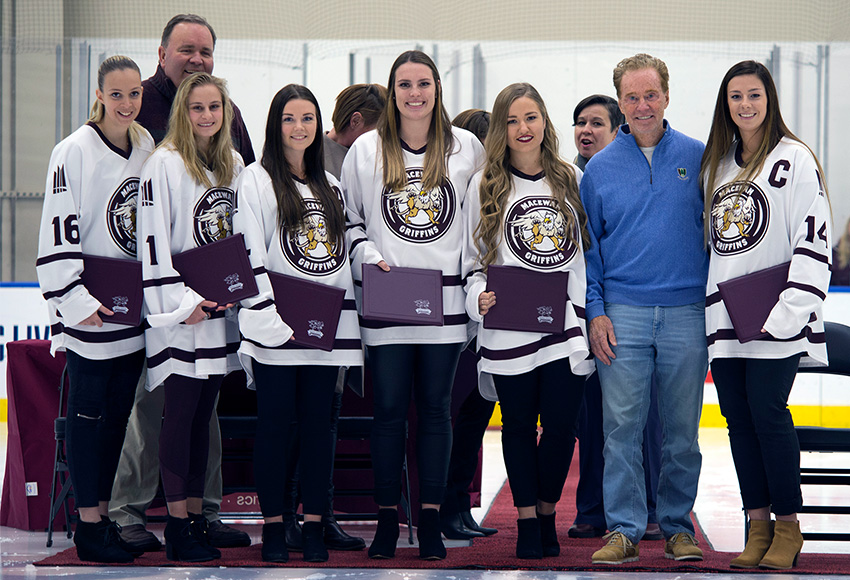 Bill Comrie (second from right) poses with women's hockey scholarship winners Dominique Scheurer, left, Sandy Heim, Nikki Reimer, Carley Jewell, Shanya Shwetz and Sydney Thomlison on Saturday night (Len Joudrey photo).
