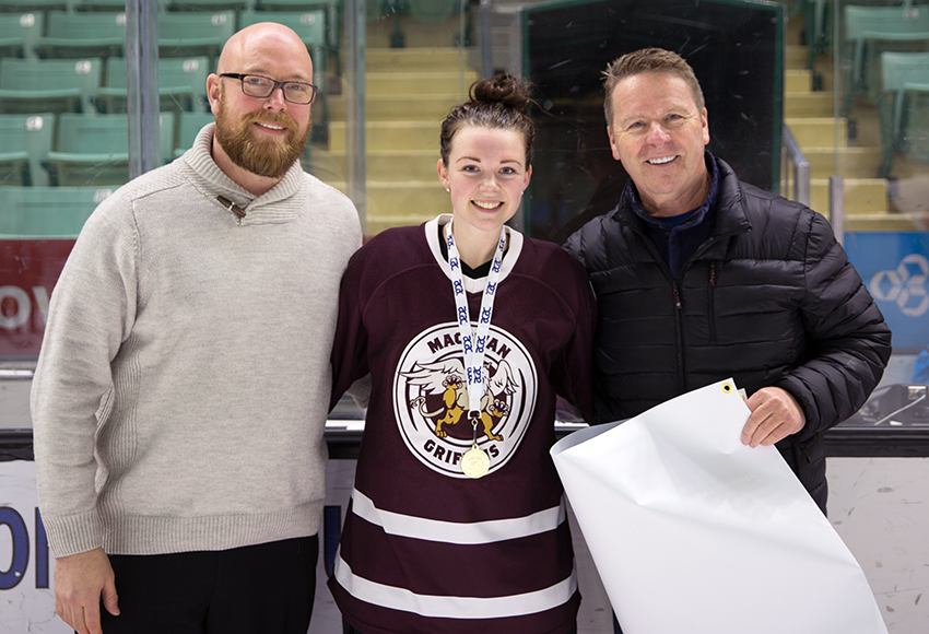 Nikki Reimer, centre, accepts her playoff MVP award following Game 5 from Red Deer College Events and Marketing Co-ordinator P.J. Swales, left, and RDC President and CEO Joel Ward (Tony Hansen photo).