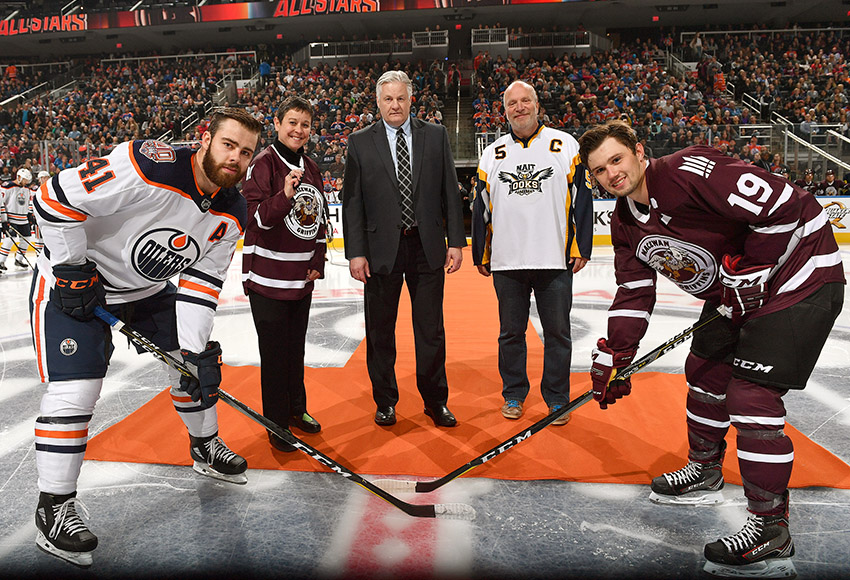 Cam Gotaas, right, seen participating in the puck drop ceremony prior to Sept. 11's NAIT-MacEwan All-Stars game against the Edmonton Oilers Rookies at Rogers Place, kicked off the 2018-19 season with a bang, netting seven points in two weekend road games (Andy Devlin, Edmonton Oilers).