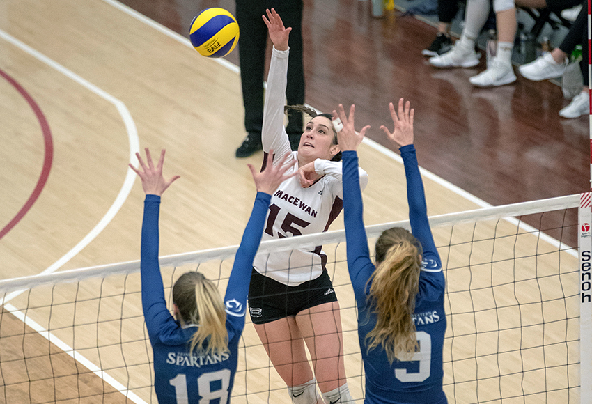 Lauren Holmes blasts a kill past the Trinity Western block during a match last weekend. She led the Griffins to a sweep of the Spartans (Eduardo Perez photo).