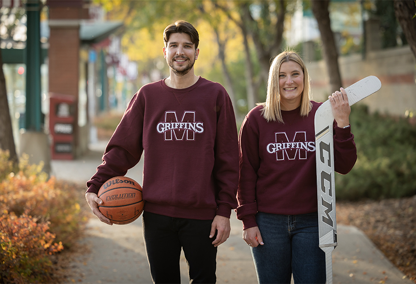 Griffins alumni Adam Boyd (basketball) and Natalie Bender (hockey) display the new 'M Crew' Sweaters (Rebecca Chelmick photo).