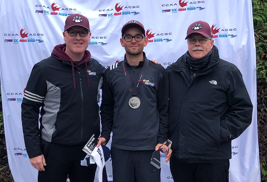 Justin Berget, centre, is flanked by MacEwan head coach Jodi Campbell, left, and assistant coach Alan Riley after winning a silver medal at the 2019 PING CCAA national championship on Friday.
