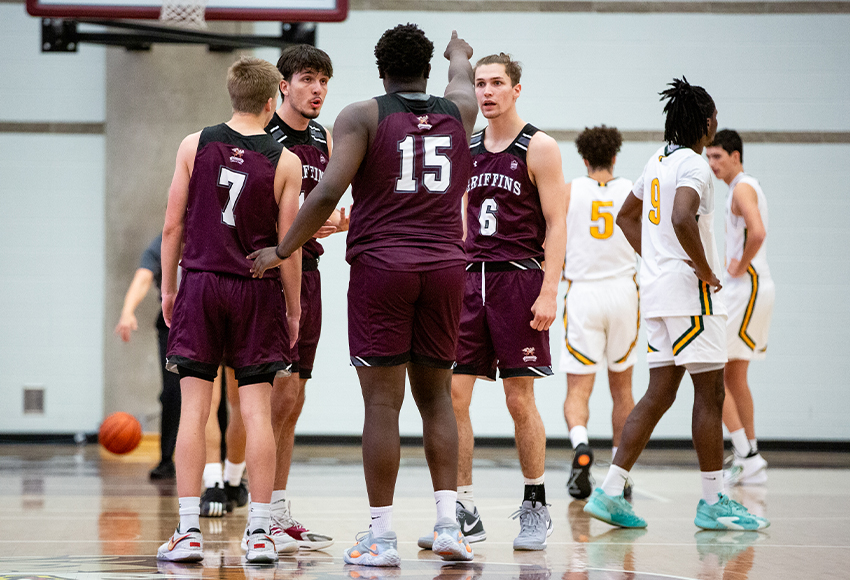 Milan Jaksic (second from left) discusses a play with teammates during a non conference game against Regina last month. MacEwan opens the season against Mount Royal on Friday (Railene Hooper photo).