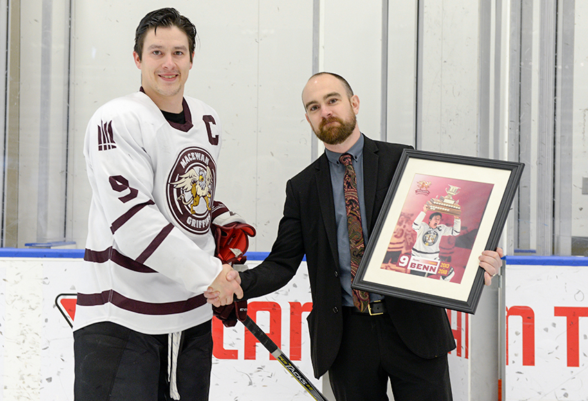 Ryan Benn receives a framed print from Griffins head coach Michael Ringrose prior to the final regular season game of his career in February.