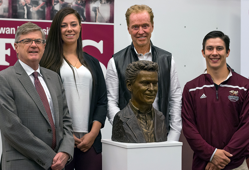 Bill Comrie, standing behind his bust - which has been placed in the Christenson Family Centre for Sport and Wellness - poses for a photo following a press conference last season highlighting his $1.5 million donation to MacEwan University. With him are (from left): former MacEwan president David Atkinson, women's hockey captain Sydney Thomlison and men's hockey captain Ryan Benn (Steven Stefaniuk photo).