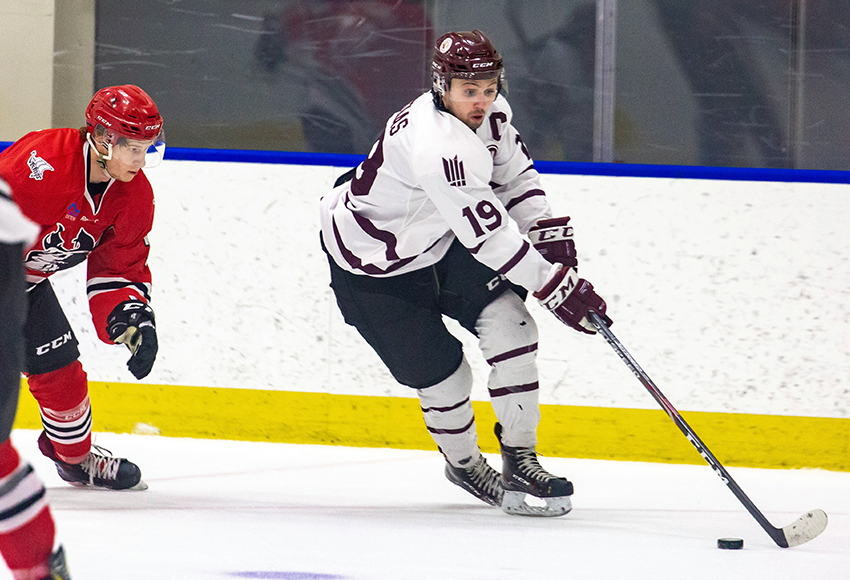 Cam Gotaas drives around a UAlberta-Augustana defender in MacEwan's 6-0 win last Saturday over Vikings. He's one of five Griffins who are averaging better than a point a game so far in January (Joel Kingston photo).