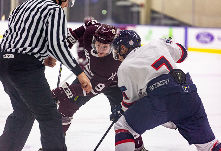 Zach Webb lines up for a faceoff against Portage's Mark Ziobro during action between the teams earlier this season. The Griffins will host the Voyageurs on Saturday, 6 p.m., Downtown Community Arena (Joel Kingston photo).