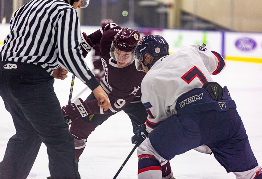 Zach Webb battles against Portage's Mark Ziobro in the faceoff dot on Friday night. A day later, he put up five points to lead MacEwan to an 8-0 win (Joel Kingston photo).