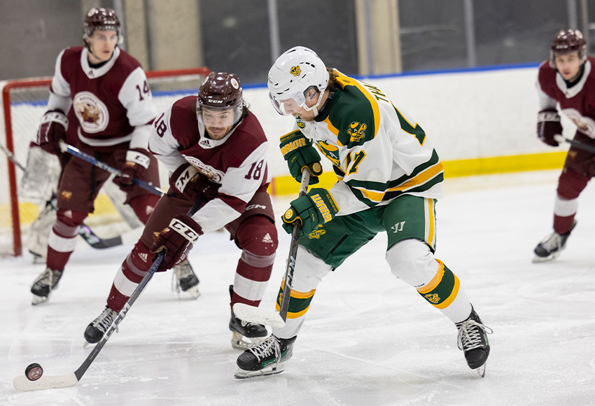 Kadyn Chabot looks to get to a loose puck under pressure from Alberta's Alex Thacker on Saturday (Rebecca Chelmick photo).