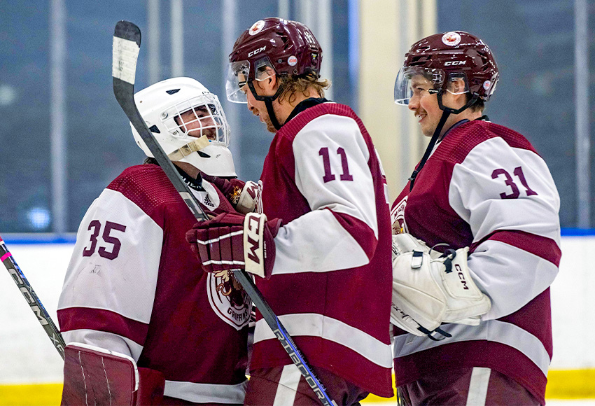 Samuel Simard (11) and Eric Ward celebrate with Carson Ironside, left, after he made 32 saves to lead MacEwan to a 5-1 win over UBC on Saturday (Derek Harback photo).