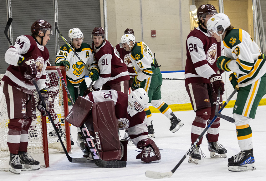 Carson Ironside covers a puck with tons of traffic in front. He made 30 saves in the contest (Rebecca Chelmick photo).