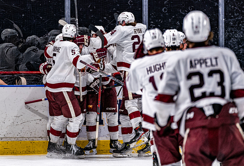 Griffins players mob Loeden Schaufler after he scored the overtime winner on Friday (Jacob Mallari, UBC Thunderbirds photo).