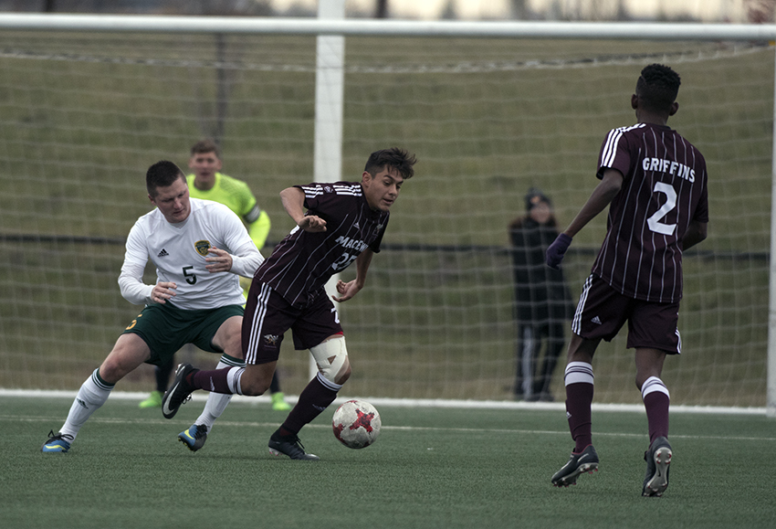 MacEwan's Christian Hernandez looks for space in the attacking third of the field against Alberta's Cameron Sjerve on Saturday (Chris Piggott photo).