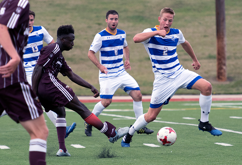 Lahai Mansaray gets off one of the Griffin's 22 shots in front of Lethbridge defender Jaden Veluw on Sunday. Despite badly outshooting the Pronghorns, MacEwan was undone by their lack of finish in a 2-1 defeat (Chris Piggott photo).