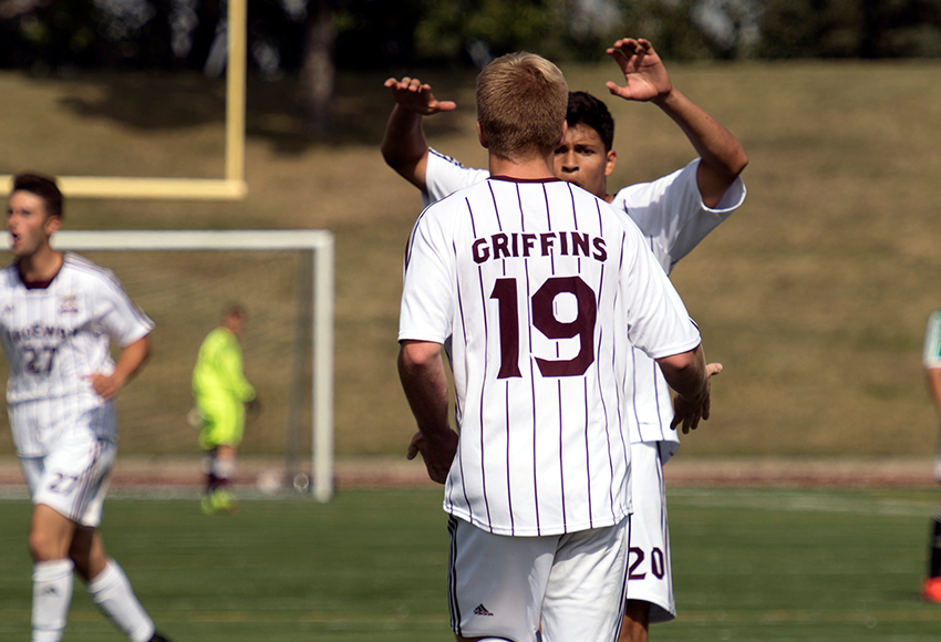 Jose Cruz helps Christian Kosmin celebrate his 82nd-minute goal. While the Griffins had all the momentum after that, they were unable to tie the match (Chris Piggott photo).