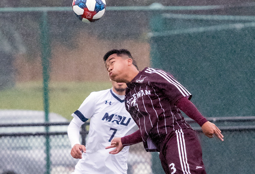 MacEwan's Michael Ho heads a ball during a game against Mount Royal University in Edmonton earlier this month. He suffered an injured ankle on Saturday at MRU's snow-covered field (Chris Piggott photo).