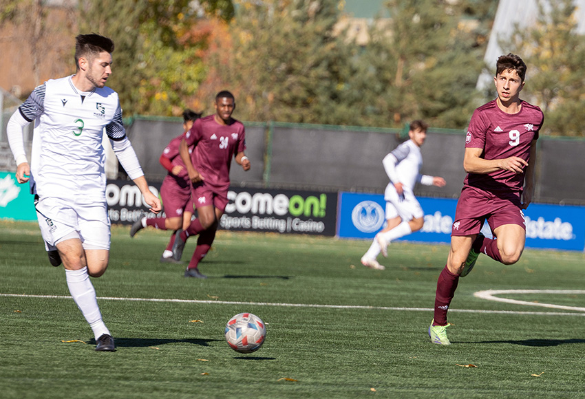 Alvin Mazaheri, right, seen competing against Saskatchewan in a game last weekend, scored the lone tally for MacEwan in a 4-1 loss to MRU on Saturday (Joel Kingston photo).