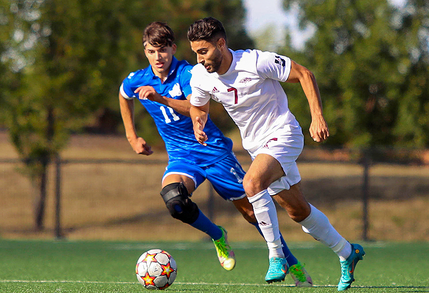 Ricky Yassin powers past a Victoria defender in a game last Saturday (Tia Schram photo).