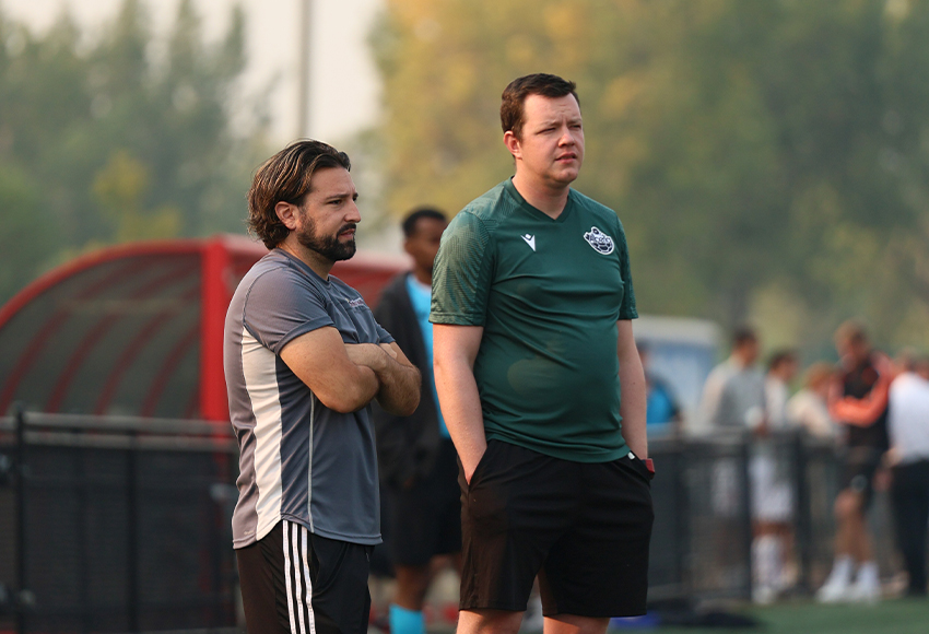 Griffins men's soccer head coach Adam Loga, left, and official Lance Phillips survey the field as they wait for word on the air quality index Sunday afternoon. The game was eventually postponed and will be rescheduled at a later date (Joel Kingston photo).