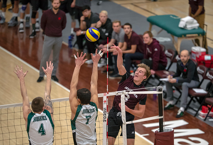 Jordan Peters tries for a kill in the face of a Huskies double block on Friday night (Robert Antoniuk photo).
