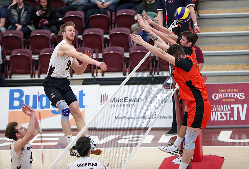 Max Vriend hits one off of a Thompson Rivers University double block on Saturday night. He finished with a match-high 22 kills in the final outing of his MacEwan Griffins career (Eduardo Perez photo).