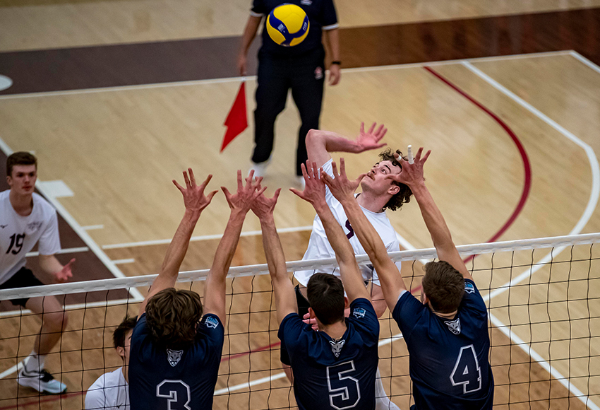 Jefferson Morrow hits against a MRU triple block on Saturday. He had the winning kill in a 3-1 victory for the Griffins (Eduardo Perez photo).