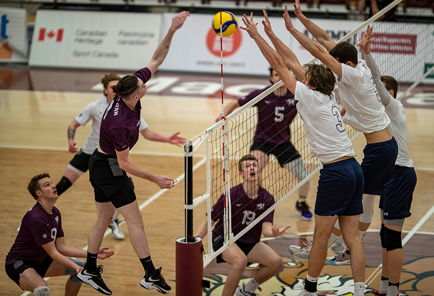 Ethan Nashim hits against MRU's double block on Friday night. The Griffins lost 3-0, but all of the sets could have gone either way (Eduardo Perez photo).