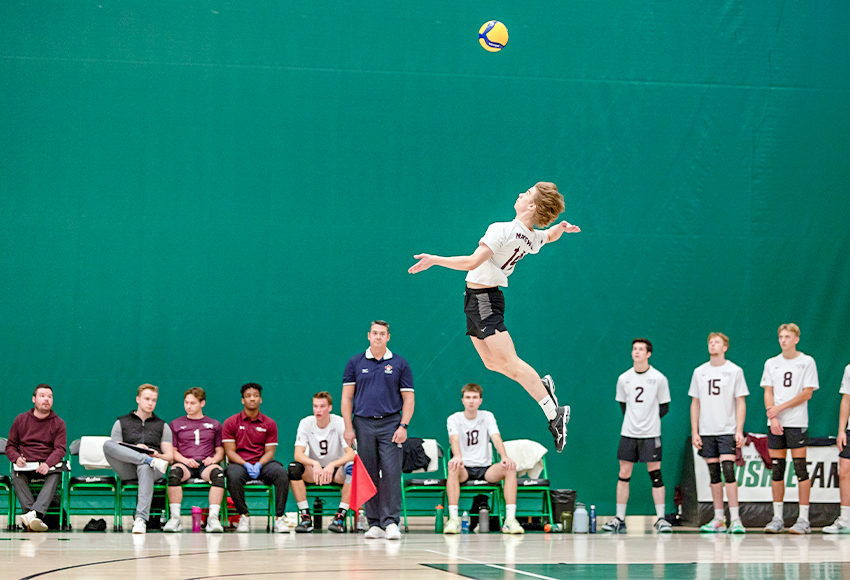 MacEwan's Daylan Andison goes up for a spin serve on Friday night (Derek Elvin/Electric Umbrella photo).