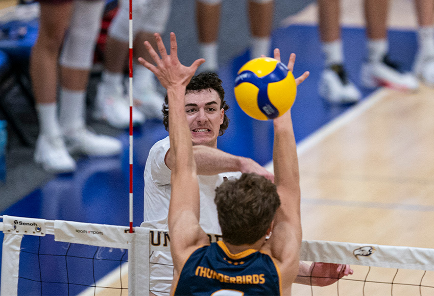 Griffins rookie Mitchell Croft hits one of his match-high 14 kills through the UBC block on Friday (Rich Lam photo).