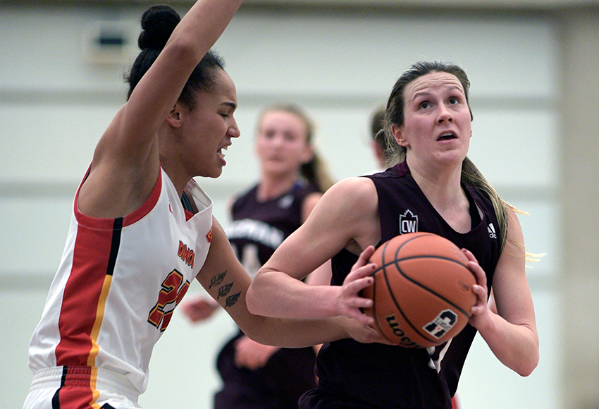 Kayla Ivicak drives against Calgary's Reyna Crawford on Saturday. She had a game-high 19 points and 11 rebounds for her sixth double double of the season (Chris Piggott photo).
