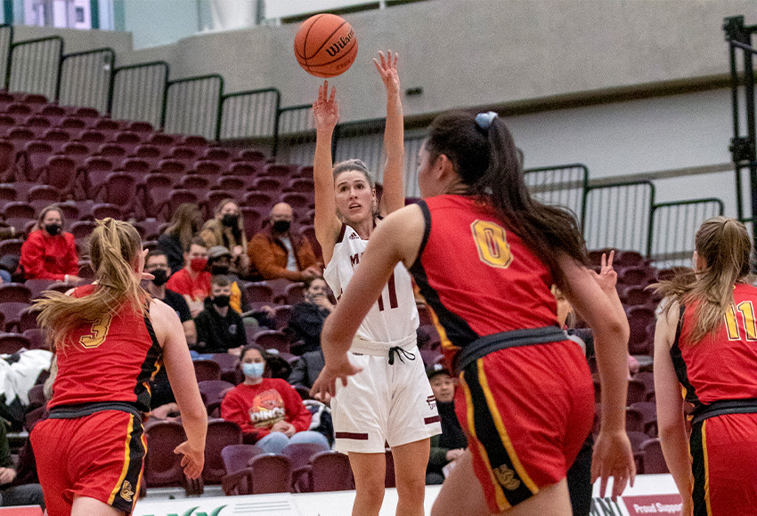 Mady Chamberlin lets a three-pointer fly at the buzzer, draining it to give MacEwan a 71-68 win over U SPORTS No. 1 Calgary on Nov. 12 (Lisa Cannon photo).